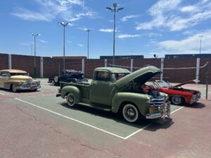 A classic car with the hood open