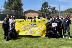 probation officers standing with a yellow banner