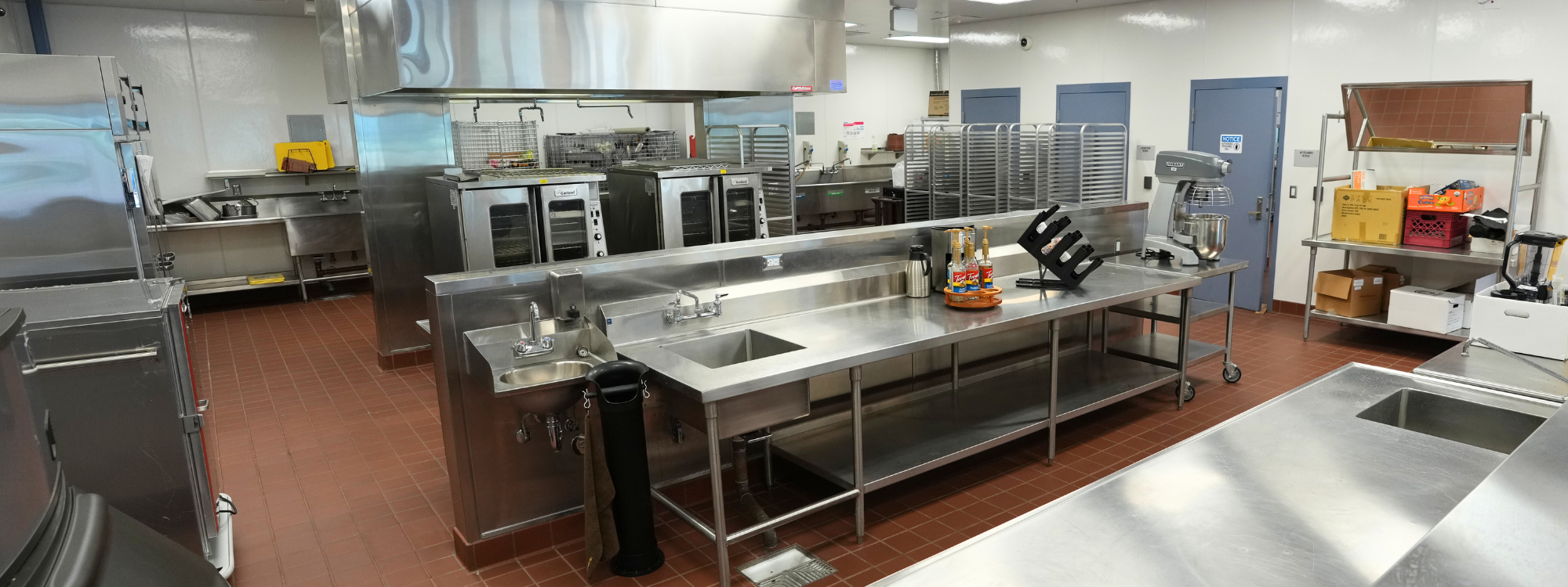 Kitchen with aluminum stoves and sinks