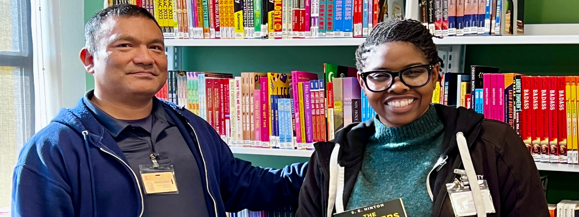 two people standing in a library